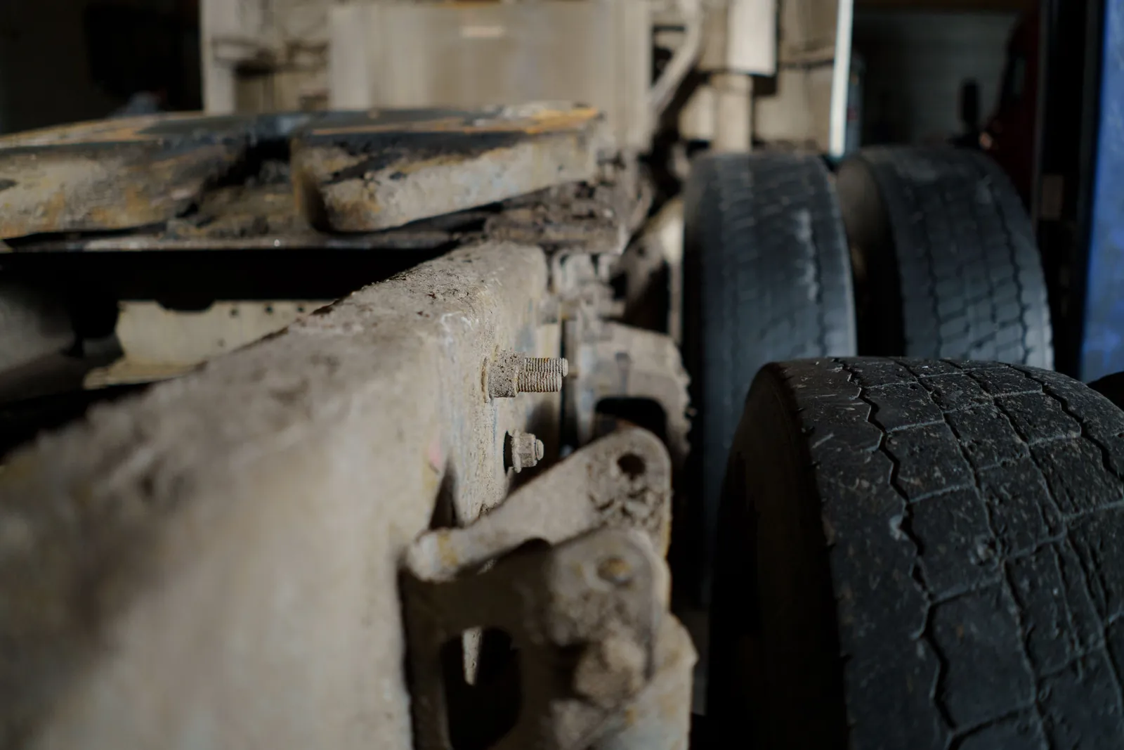 A close-up of a truck frame and drive tires