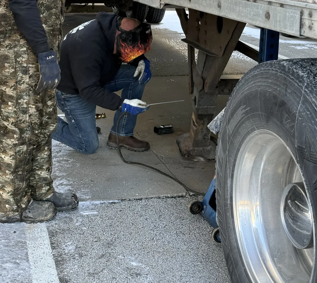 Superior technicians working at the wheel end of a customer's trailer