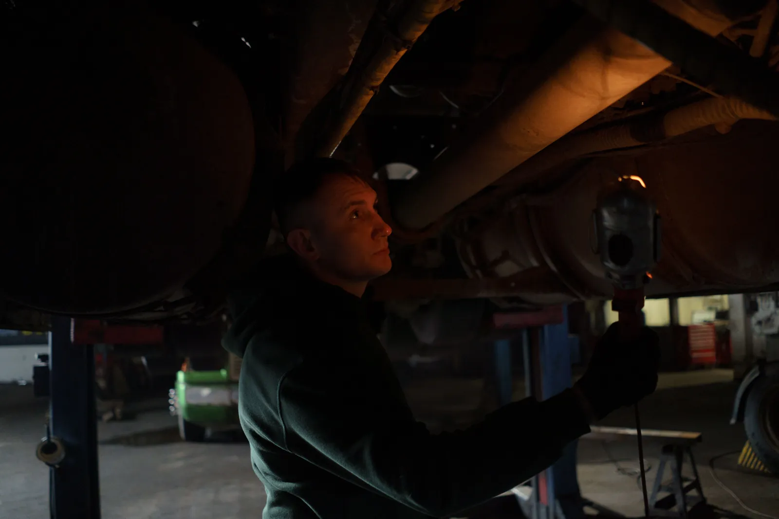 A technician working under a truck on a lift