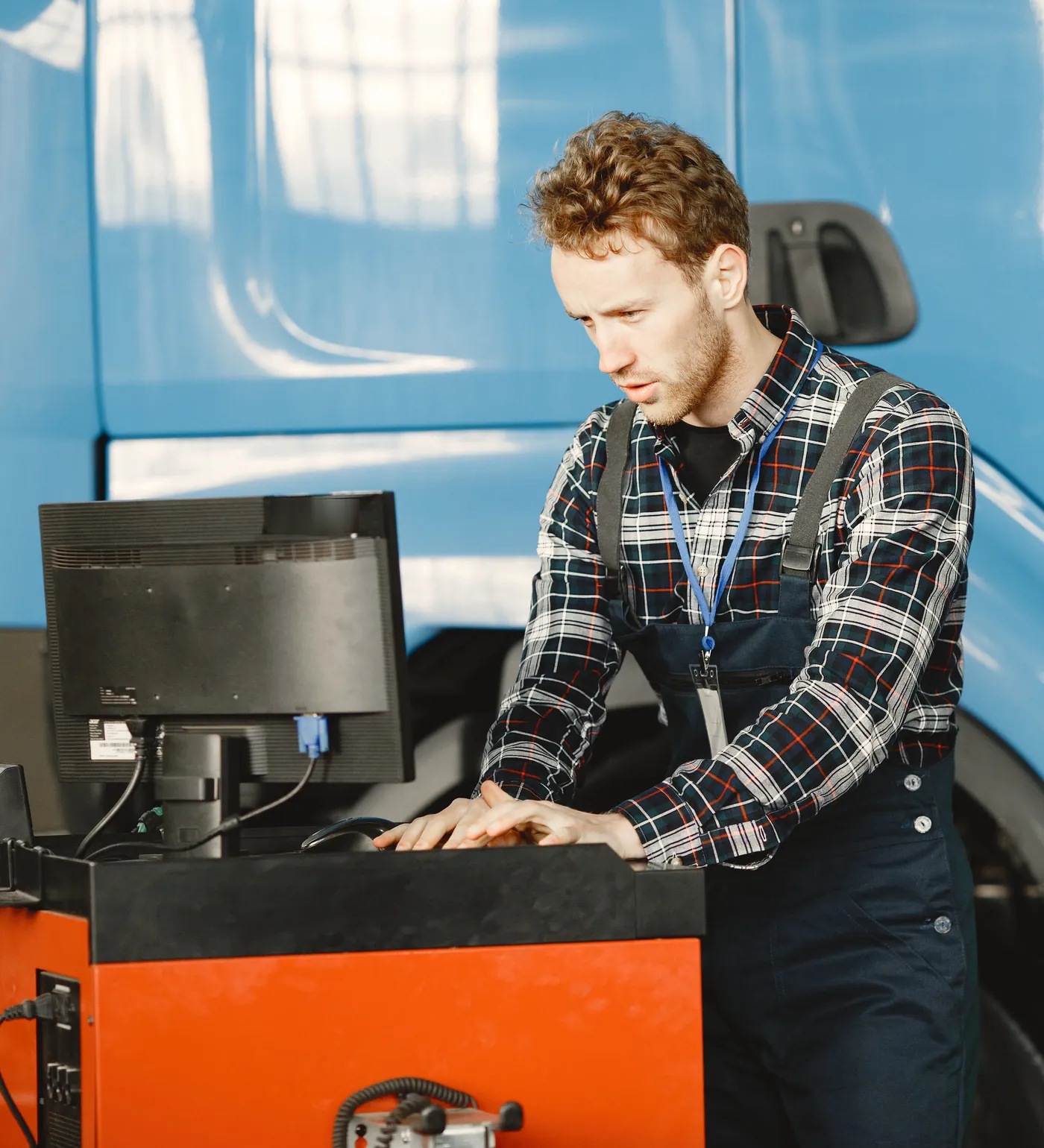 A technician at a diagnostic computer on its cart