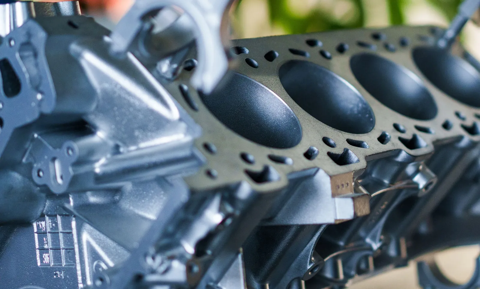 A bare diesel engine block with the cylinder bores exposed