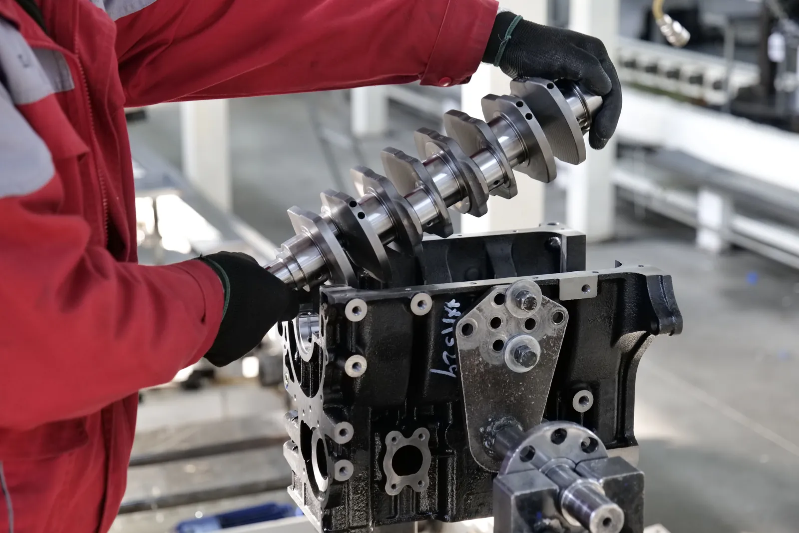 A crankshaft going into a bare diesel engine block