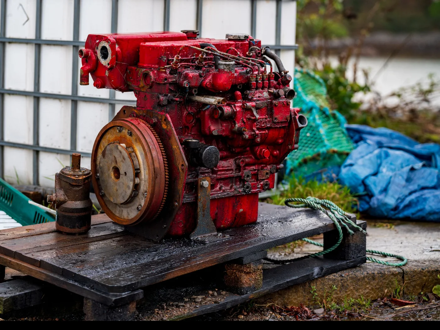 A diesel engine out of its machine, sitting on a pallet