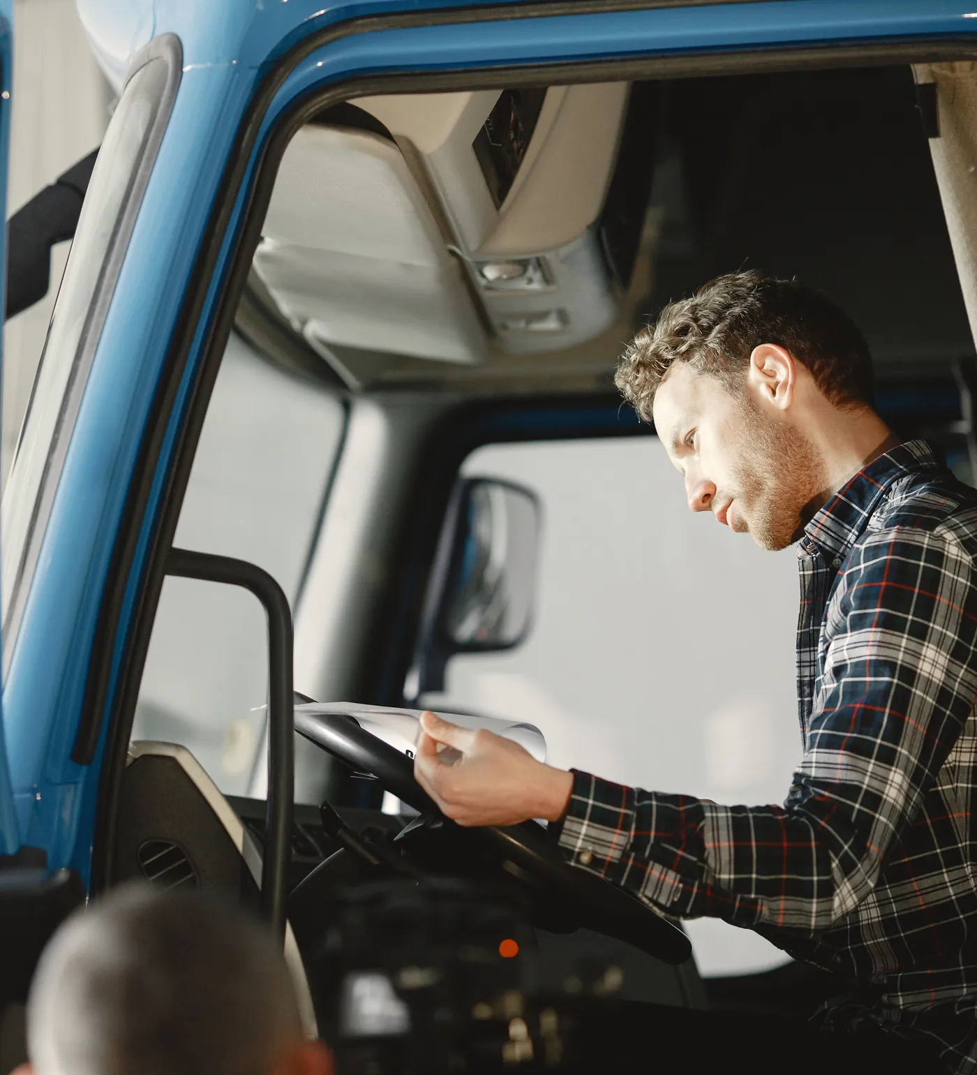 A technician in the cab of a truck