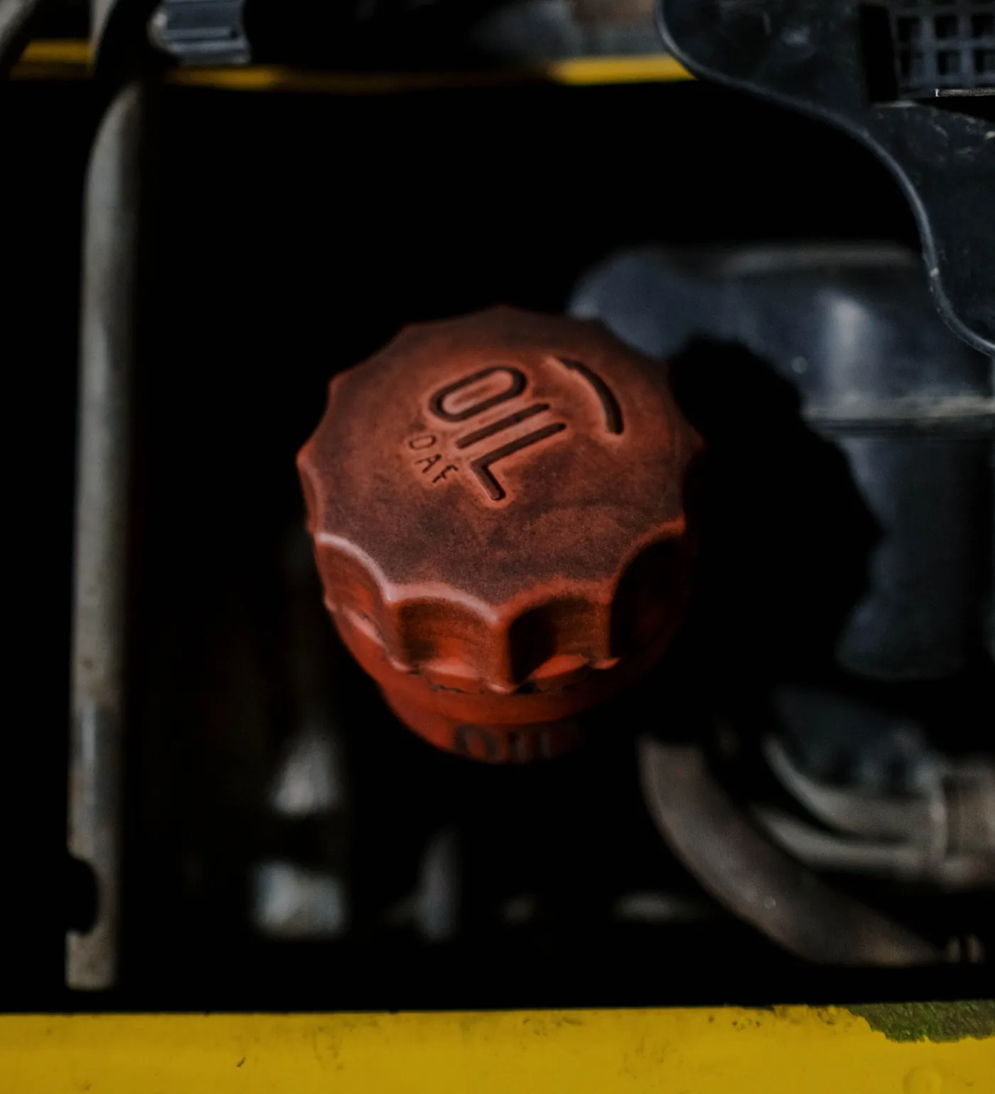 The engine oil fill cap on a truck, marked OIL