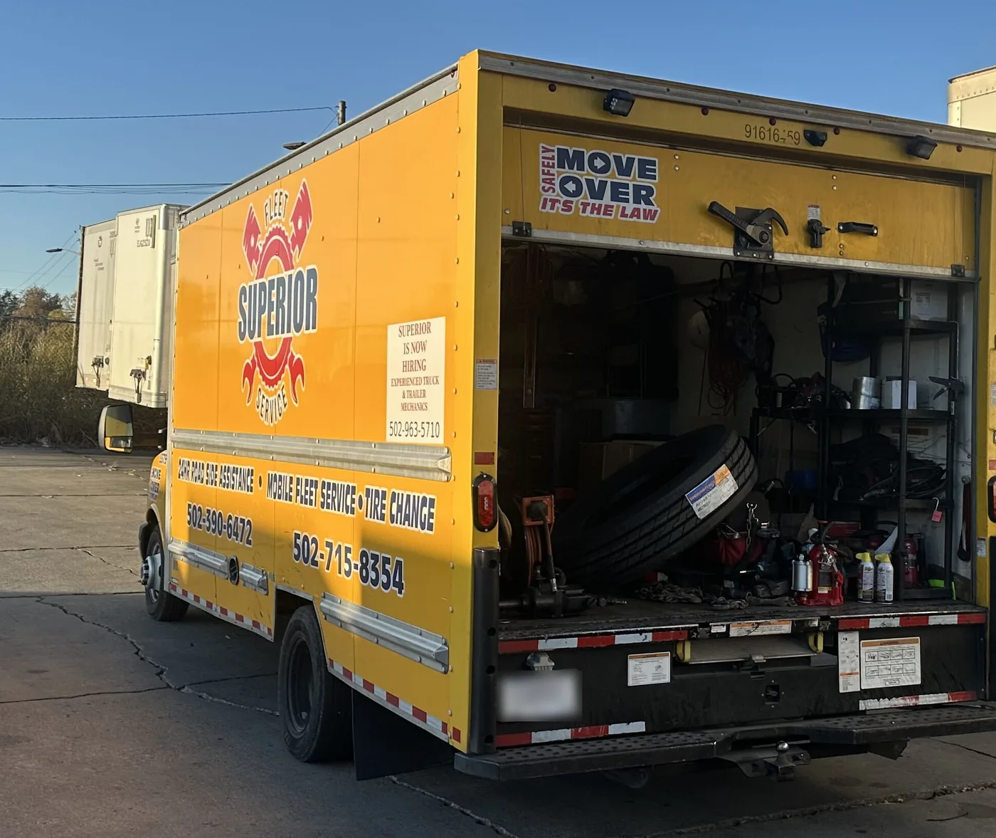 Superior's service box truck with the rear open, stocked with tires, fluids and parts