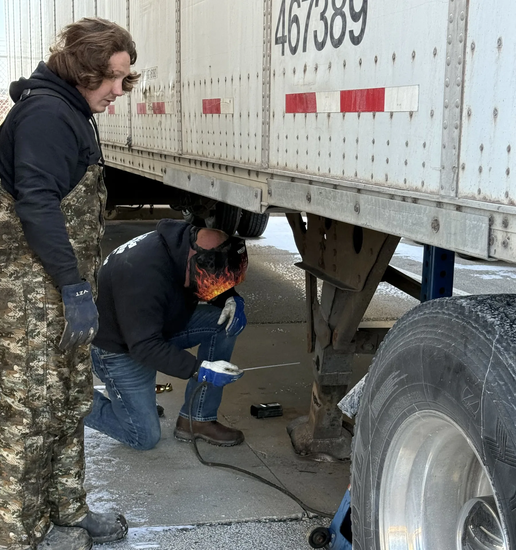 Superior technicians pulling a trailer wheel to replace the tire